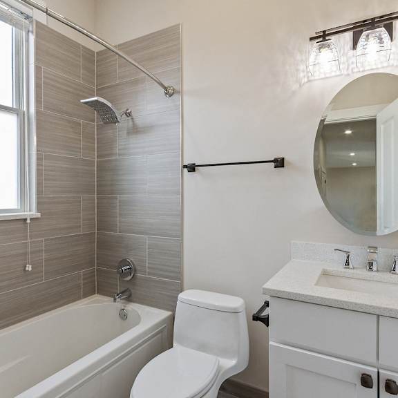 a bathroom with a sink toilet and a bath tub