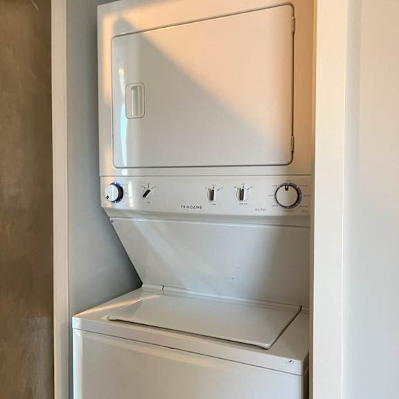 an empty laundry room with a washer and dryer