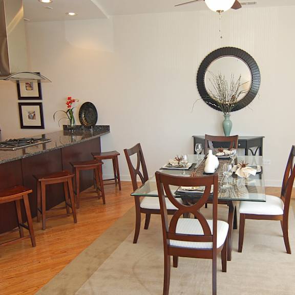a dining room with a glass table and chairs