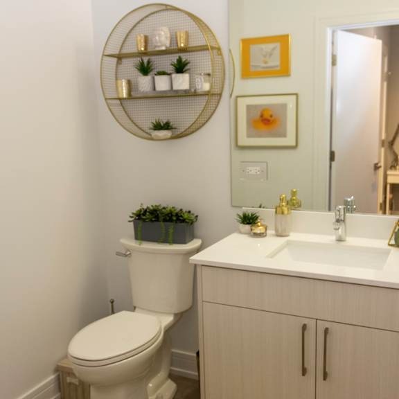 a small bathroom with a toilet and a sink and a mirror