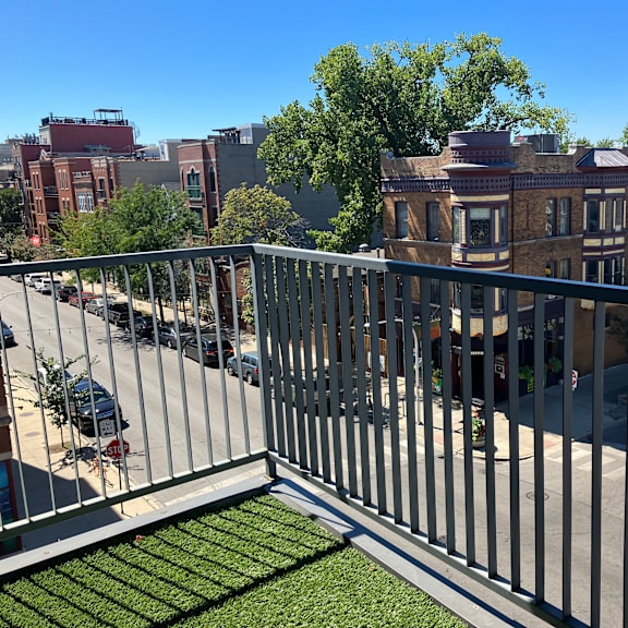 a balcony with a view of a city street and buildings