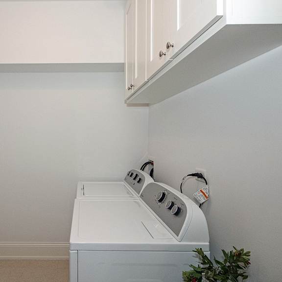 a laundry room with a washer and dryer and a sink