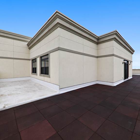 a large roof terrace with a blue sky in the background