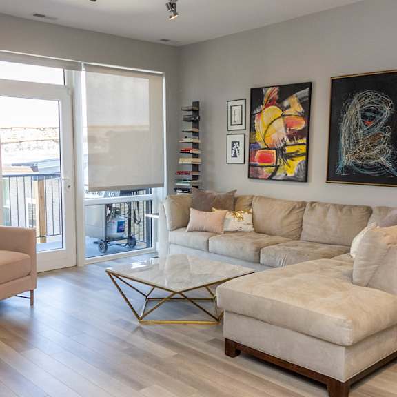 a living room with a couch and a chair and a table