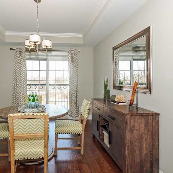 a dining room with a table and chairs and a window