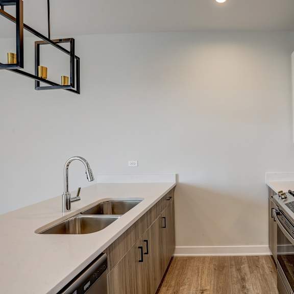 a kitchen with a sink and stove and a microwave