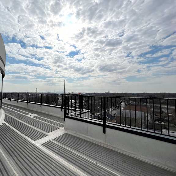 a balcony with a view of the city and the sky
