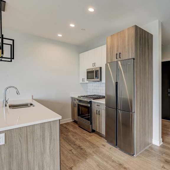a kitchen with stainless steel appliances and a refrigerator