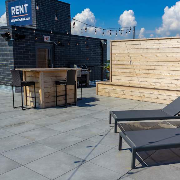 a outdoor balcony with lounge chairs and tables 