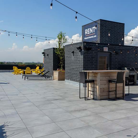 an outdoor patio with a grill and a bar on the roof of a building at talman 1554, chicago illinois