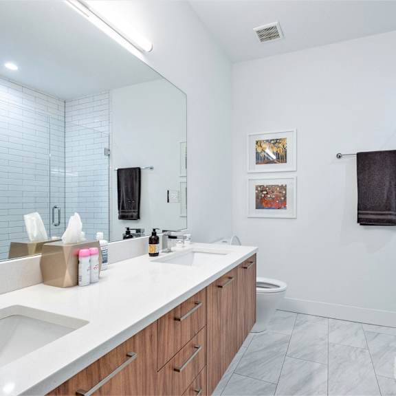 a bathroom with a large mirror and a sink and a shower