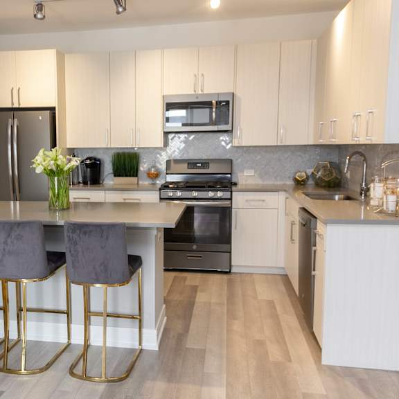 a kitchen with stainless steel appliances and white cabinets