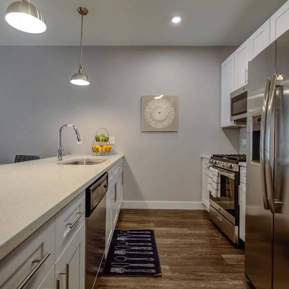 a kitchen with a large counter top and a stainless steel refrigerator at barrington 101, illinois