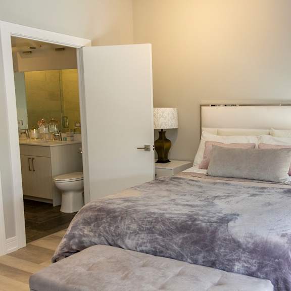 a bedroom with a bed and a bathroom