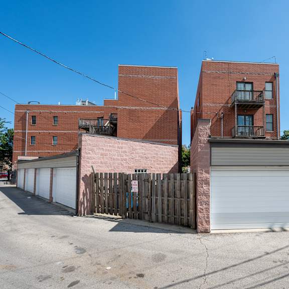 a red brick building with a white garage door in front.
