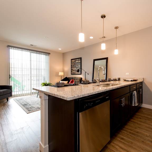 a kitchen with an island and a living room with a couch