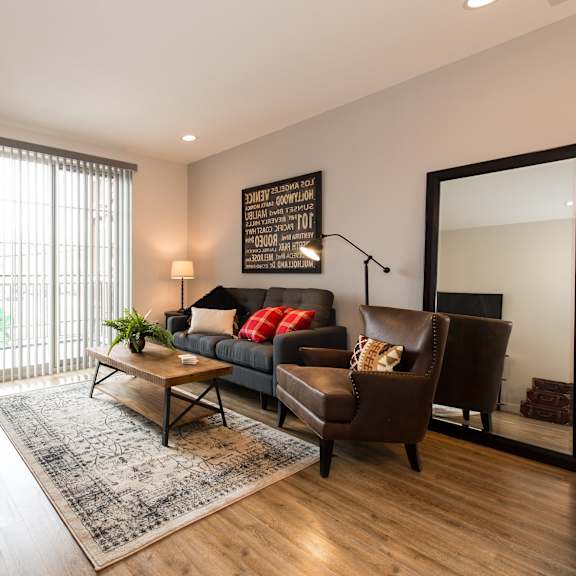 a living room with a couch and chairs and a table