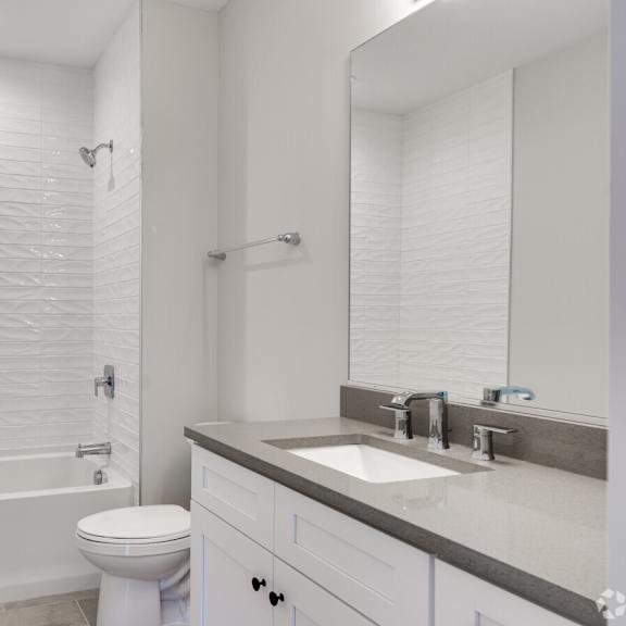 a bathroom with a sink toilet and a shower