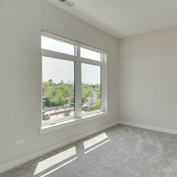 an empty living room with a large window