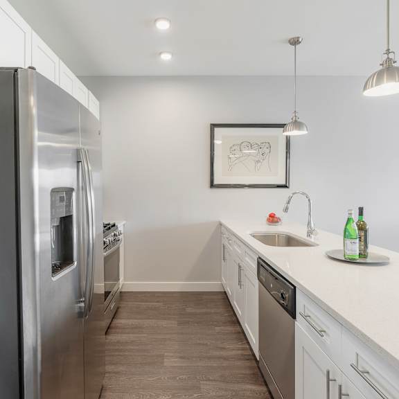 a kitchen with stainless steel appliances and white cabinets at barrington 101, barrington, il