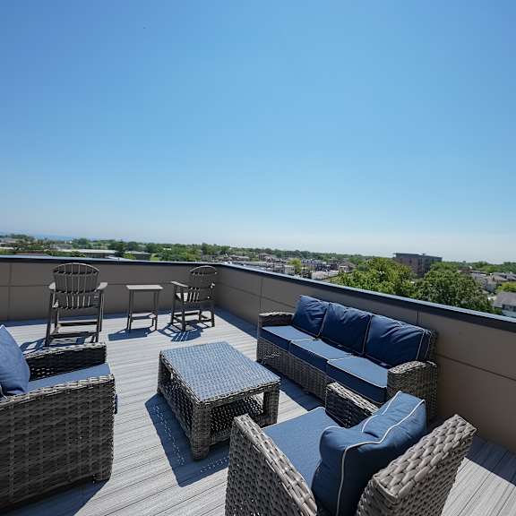 a roof deck with furniture and a view of the city
