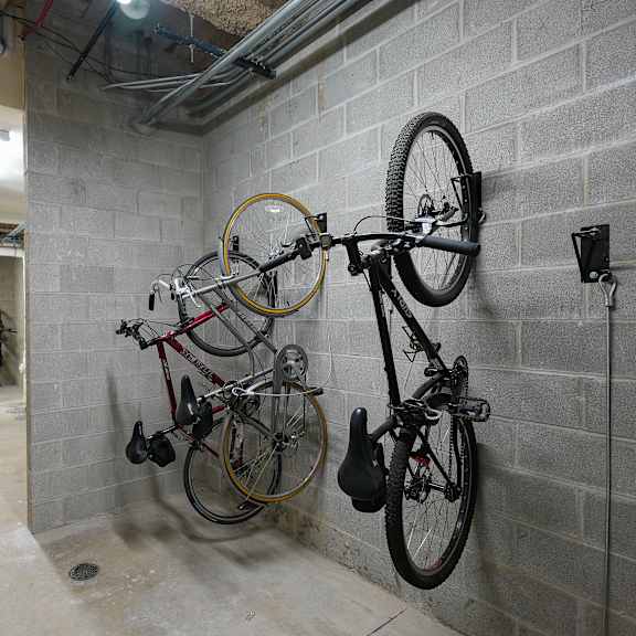 a basement room with two bikes hanging on the wall