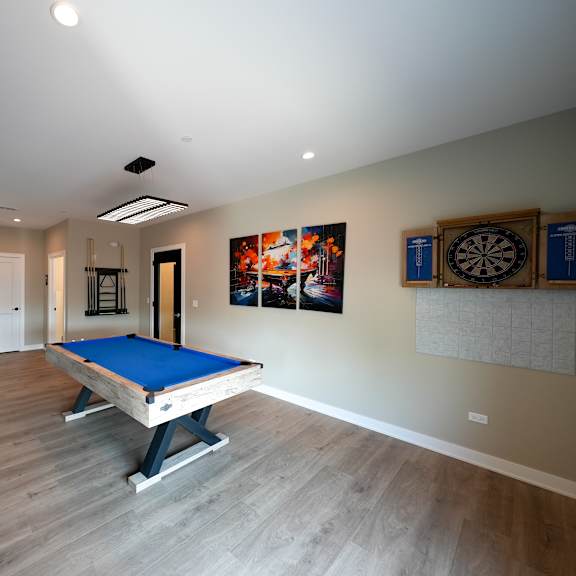 a rec room with a pool table in a house