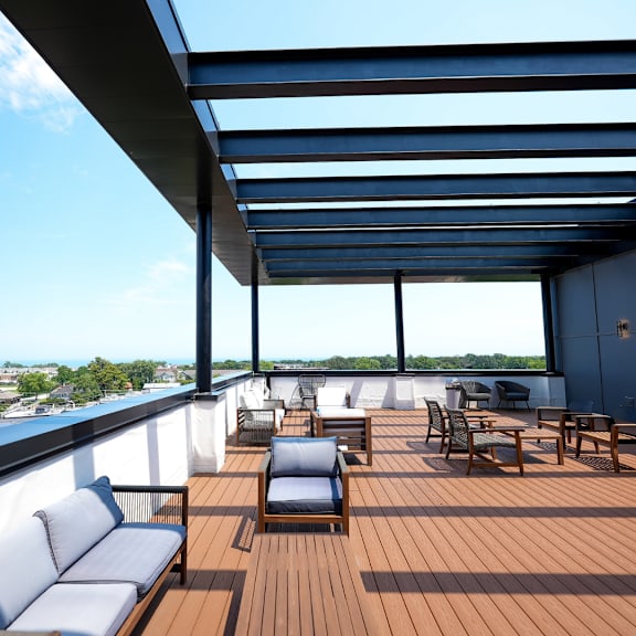a deck with couches and tables on top of a roof