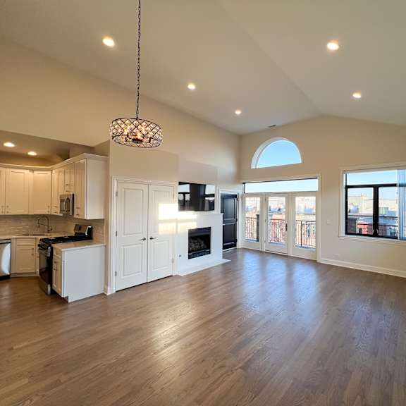 a modern kitchen with wooden floors and a large island.