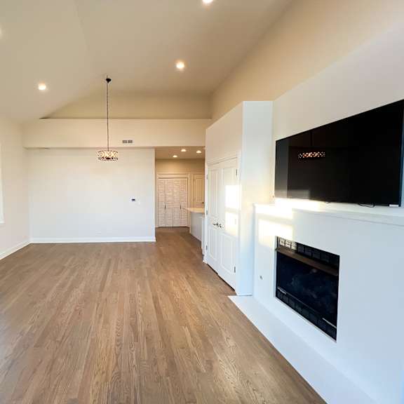 a spacious living room with a fireplace and a television.