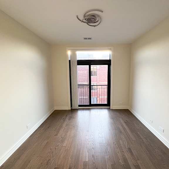 a room with wooden floors and a ceiling fan.
