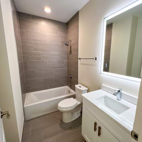 a bathroom with a white toilet, a white sink, and a white bathtub.
