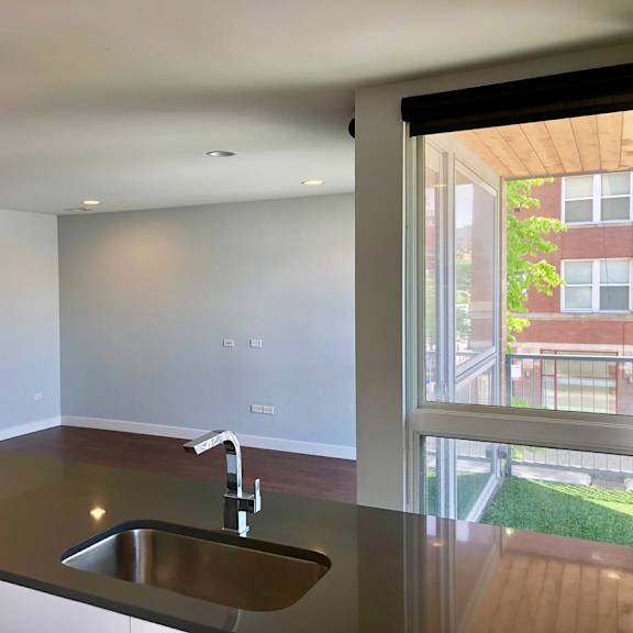 an empty kitchen with a sink and a window