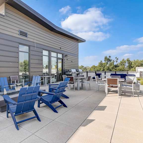the patio of the building has blue chairs and tables at barrington 101, chicago