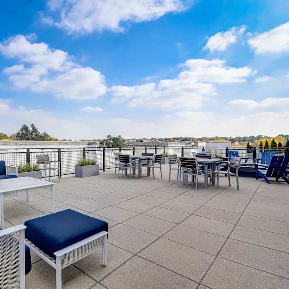 the terrace of the building has seating and tables at barrington 101, chicago