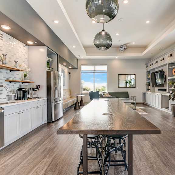 a large kitchen and dining room with a large wooden table at barrington 101, barrington illinois