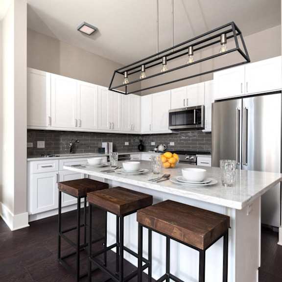 a kitchen with a center island and three stools