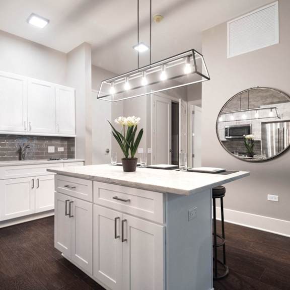 a kitchen with white cabinets and a white counter top