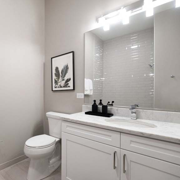 a bathroom with a toilet and a sink and a mirror