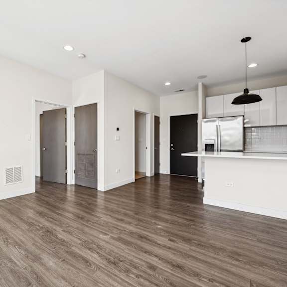 open-concept layout at highpoint buena park on broadway featuring a modern kitchen, spacious living and dining areas, and oversized windows in a luxury apartment near montrose beach in chicago’s buena park neighborhood