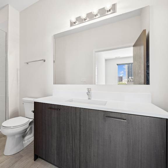 modern bathroom at highpoint buena park on broadway featuring sleek tilework, contemporary fixtures, and ample vanity space in a luxury buena park apartment in chicago
