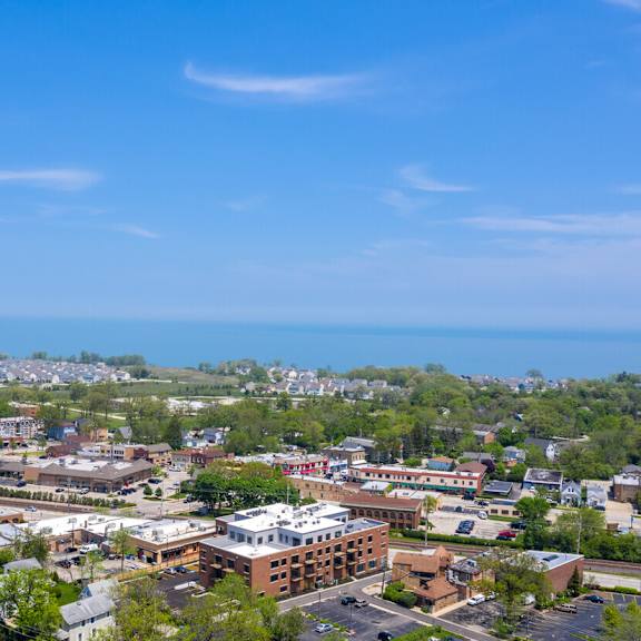 an aerial view of a city with the ocean in the background