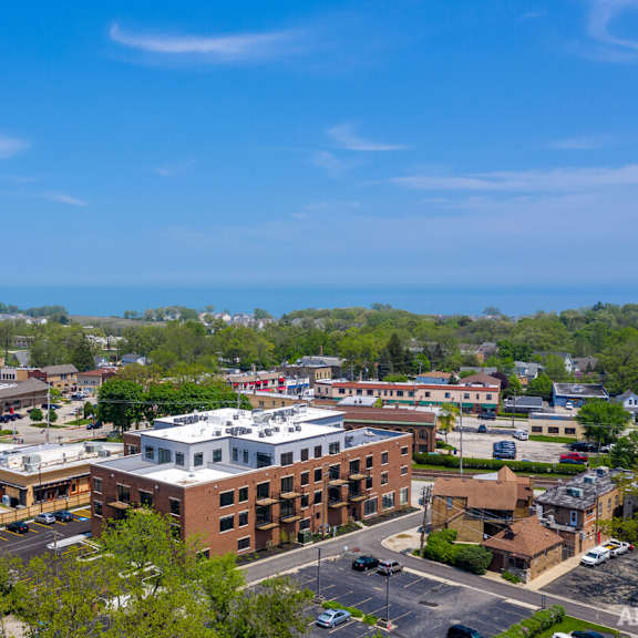 an aerial view of a city with buildings and the ocean in the background