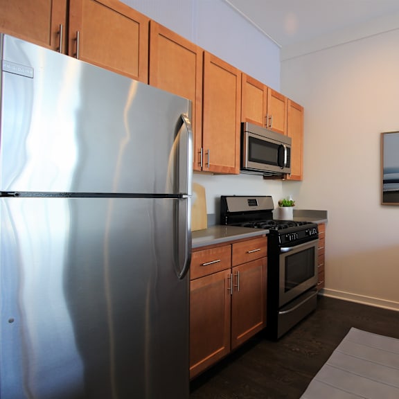 a kitchen with stainless steel appliances and wooden cabinets