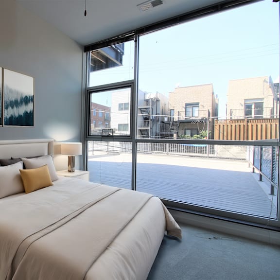 a bedroom with a large bed and a large window