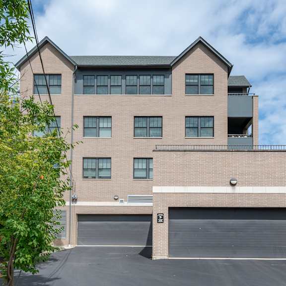 a large two-story building with a garage door in front.