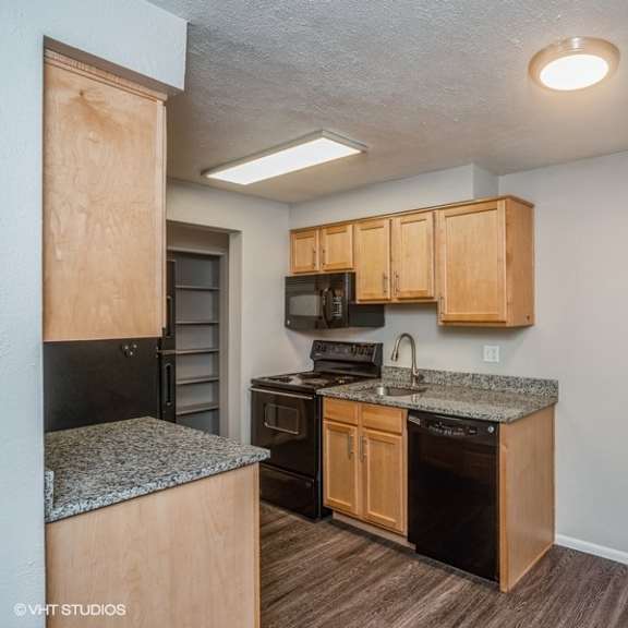 honey oak colored cabinets and a dishwasher at 1190 s bellaire st in denver, co
