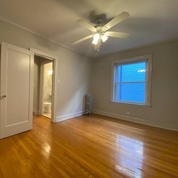 hardwood flooring and a ceiling fan - charlie chaplin one bedroom