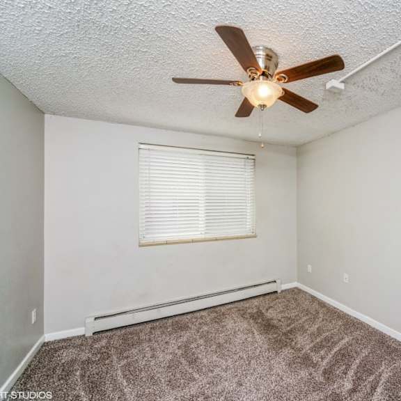 bedroom with a ceiling fan and plush carpeting at 136 s penn in denver, co
