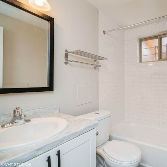 sparkling white bathroom with updated cabinets at 1443 elizabeth